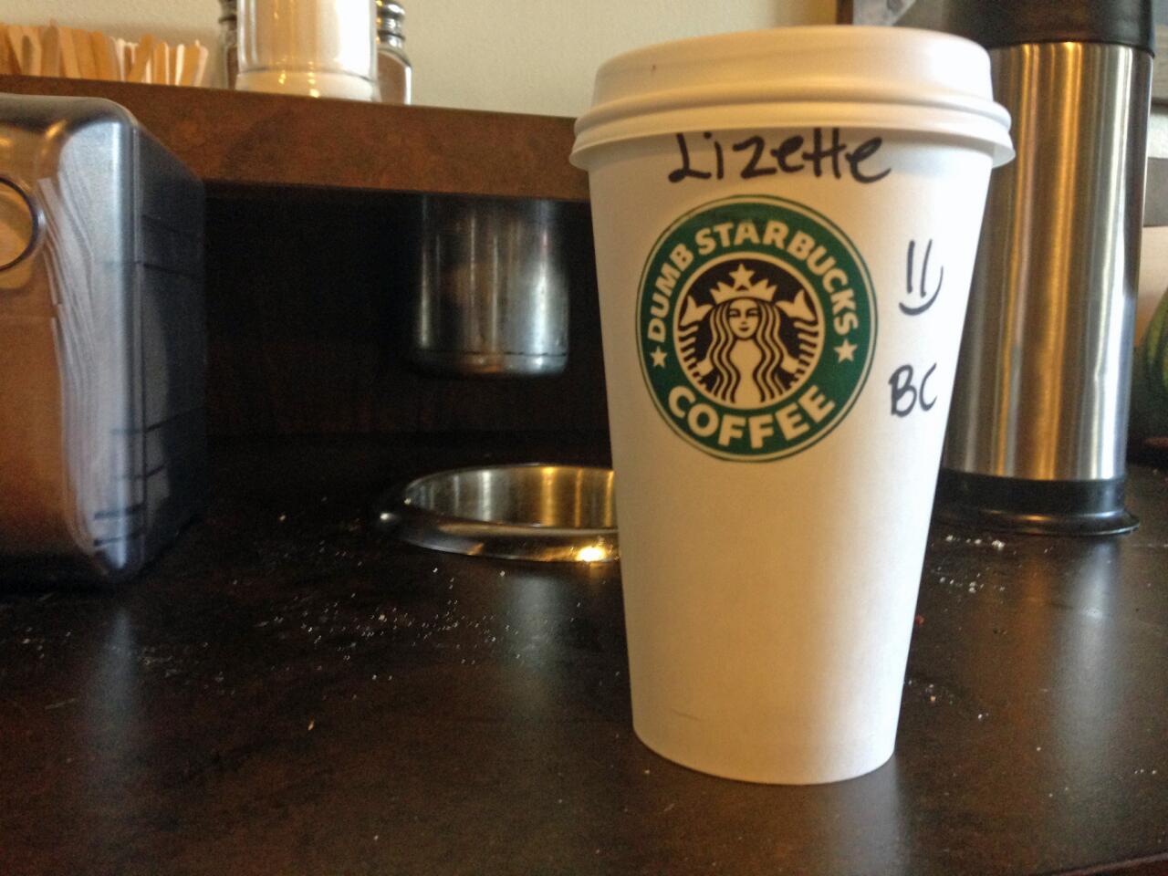 A Dumb Starbucks cup with its pasted-on sticker.