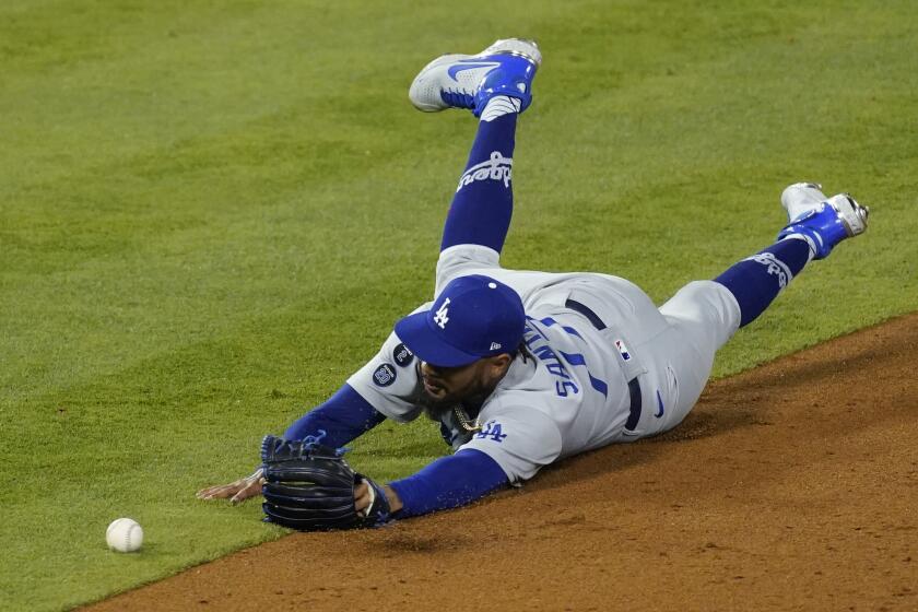 Dodgers relief pitcher Dennis Santana is unable to come with a ball hit by the Angels' Jon Jay in the sixth inning Saturday.