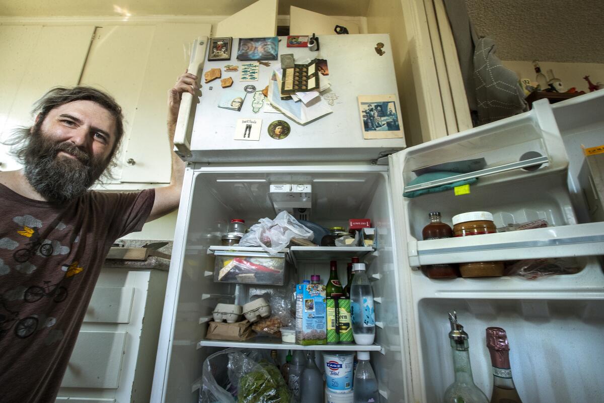 Josh Steichmann is photographed next to his refrigerator