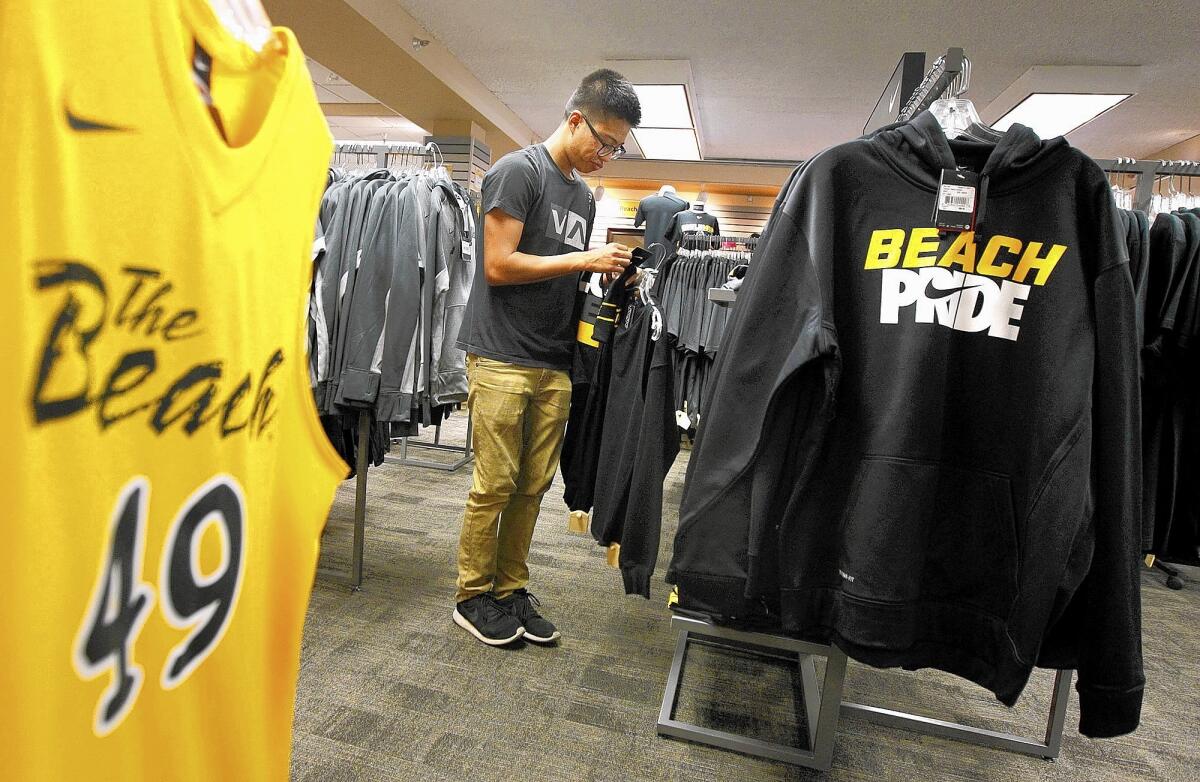 A student at Cal State Long Beach's bookstore looks at merchandise branded with the campus' unofficial nickname, the Beach.