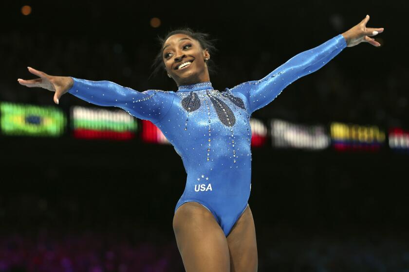 United States' Simone Biles celebrates winning the gold medal during the women's all-round final.