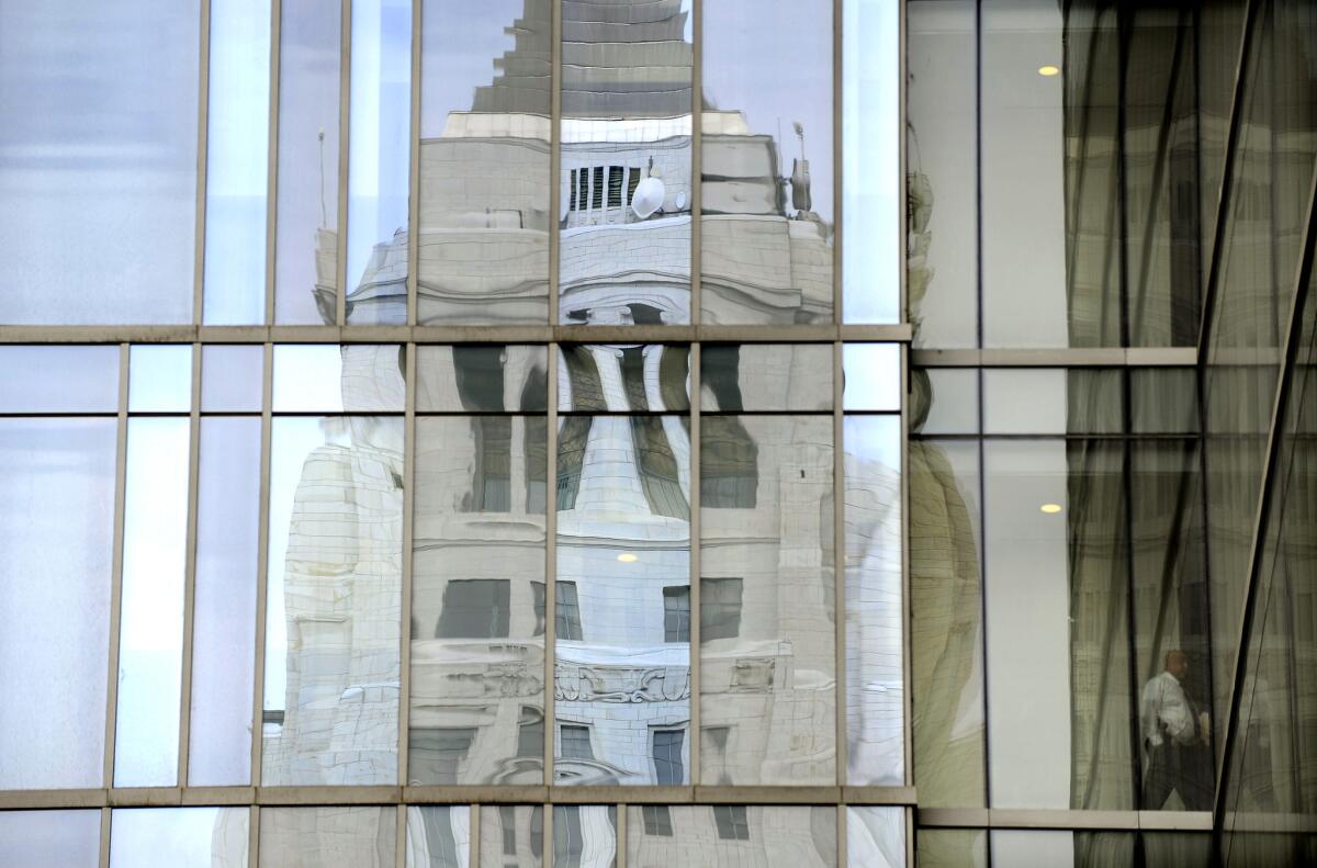 City Hall is reflected in the windows of LAPD headquarters in downtown Los Angeles.