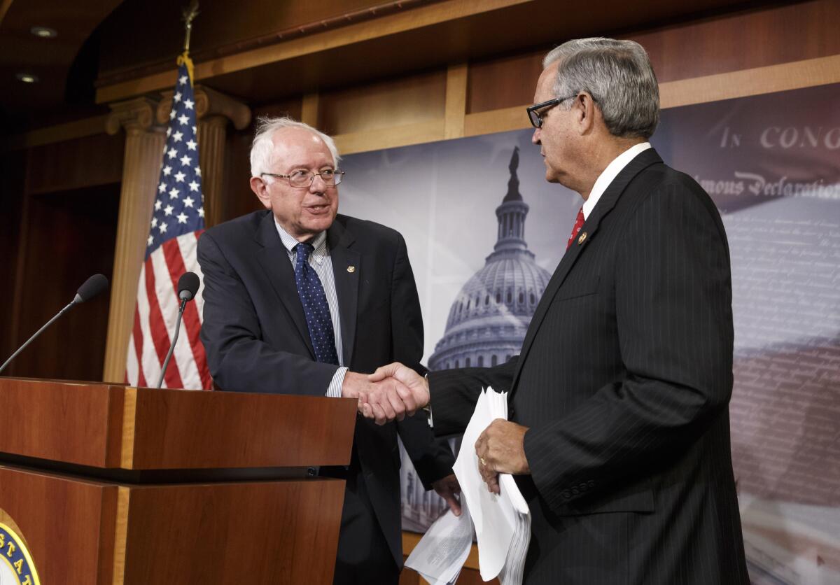Congressional negotiators Sen. Bernie Sanders (I-Vt.), left, and Rep. Jeff Miller (R-Fla.) shake hands as they outline their agreement on a compromise to fix the vast healthcare system responsible for treating the nation's veterans.