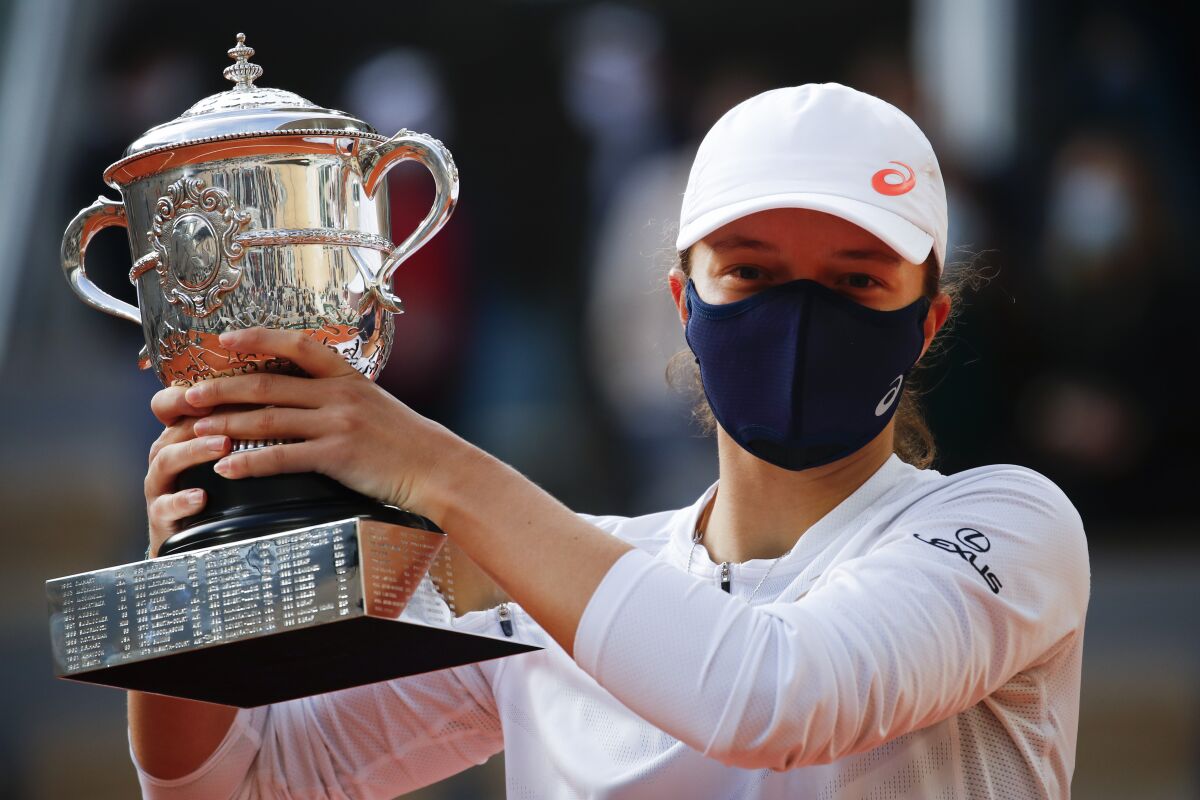 Poland's Iga Swiatek holds the trophy after winning the final match of the French Open tennis tournament.