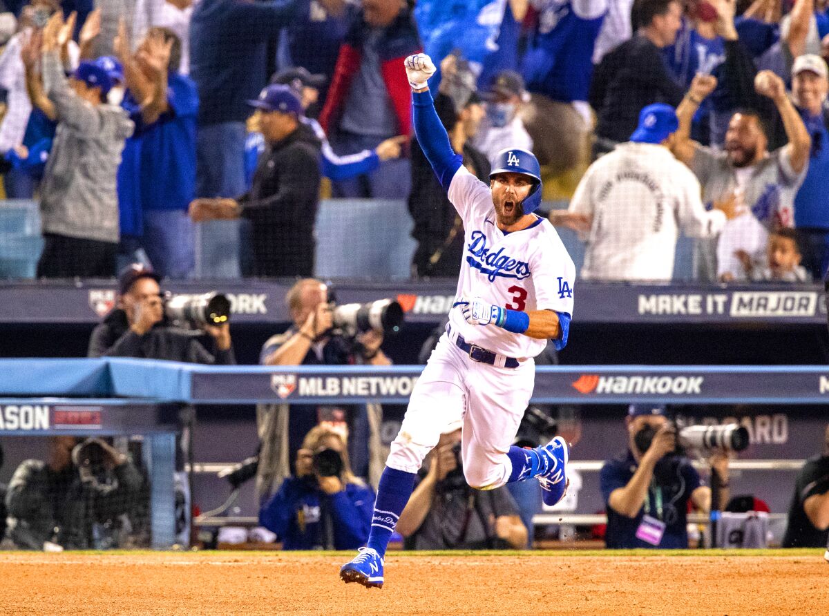 The Dodgers' Chris Taylor celebrates Oct. 6, 2021, after hitting a walk-off homer against St. Louis in the NL wild-card game.