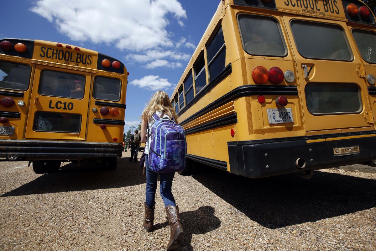 A student prepares to get on a school bus.