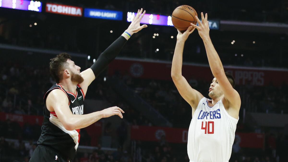 Clippers center Ivica Zubac, right, trying to score over Portland center Jusuf Nurkic on Tuesday, says he is rushing his shots.