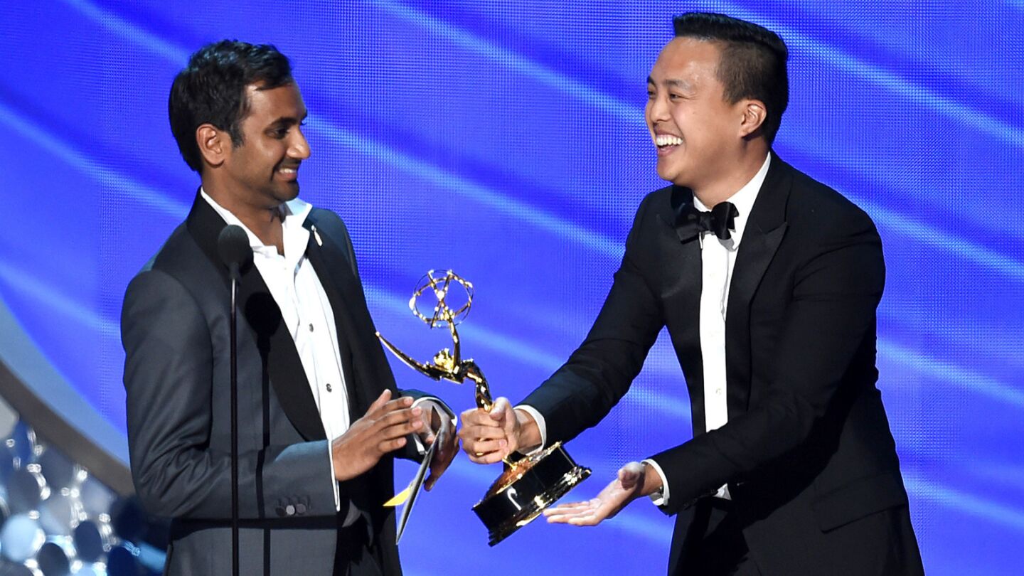 Aziz Ansari and Alan Yang accept the award for writing for a comedy series for "Master of None."