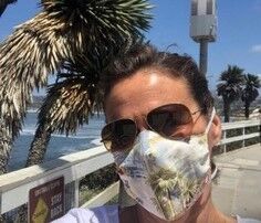 Alessandra Sgubini wears one of the masks that Shari Frymann made from an old bathroom curtain that featured scenes of La Jolla. Frymann is offering a free La Jolla mask to the first reader who emails her at sharifrench@gmail.com.