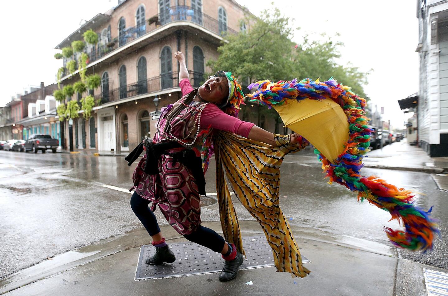This year New Orleans turns 300, and nobody celebrates like this city. A woman dances on a French Quarter street in October 2017, just before Hurricane Nate made landfall.