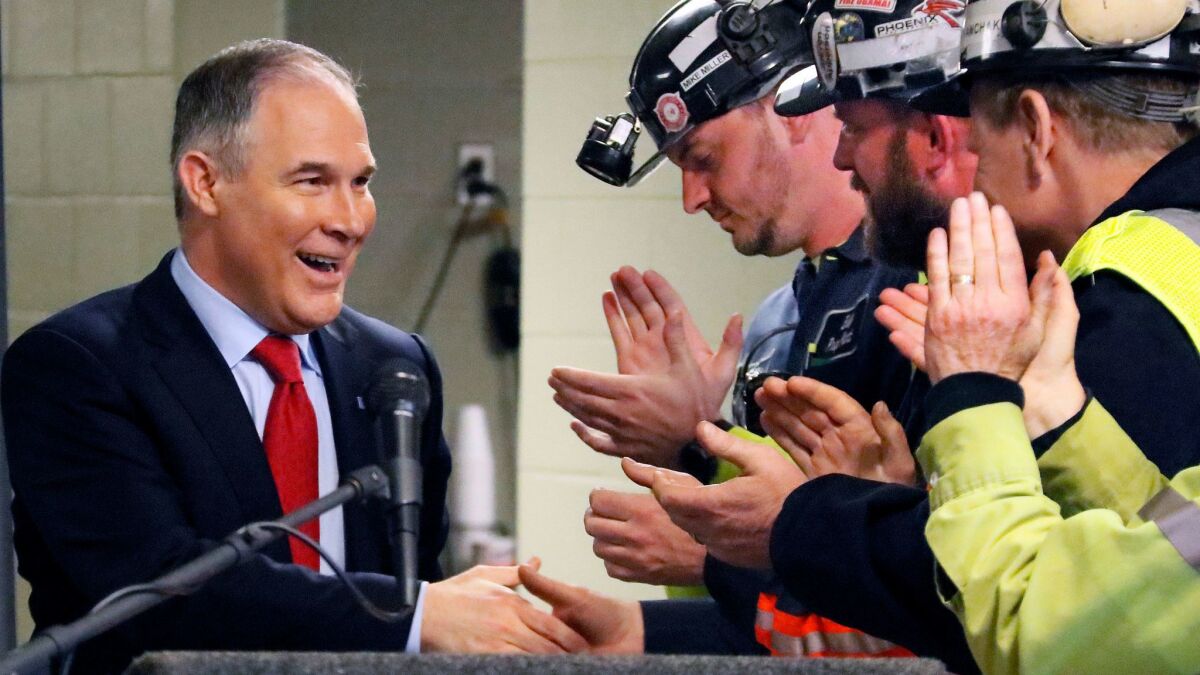 EPA Administrator Scott Pruitt, left, makes nice with coal miners during a visit to rural Pennsylvania this month.