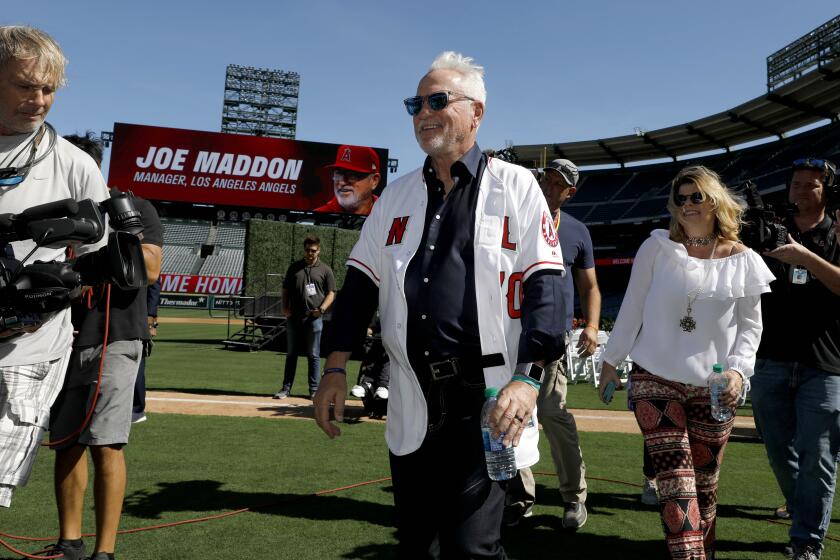 ANAHEIM, CALIF. -- THURSDAY, OCTOBER 24, 2019: The Los Angeles Angels of Anaheim introduce Joe Maddon, shown with his wife Jaye, right, as latest manager at a press conference held at Angel Stadium in Anaheim, Calif., on Oct. 24, 2019. (Gary Coronado / Los Angeles Times)
