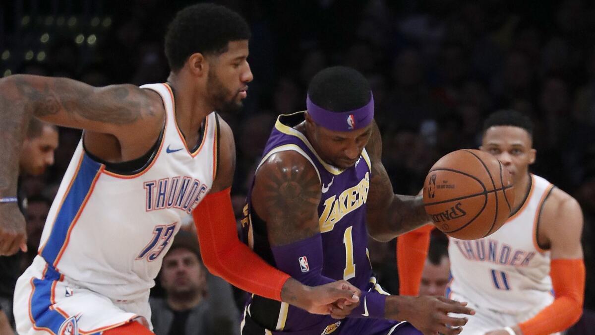 Lakers guard Kentavious Caldwell-Pope steals the ball from Oklahoma City's Paul George during a Jan. 2 game at Staples Center.