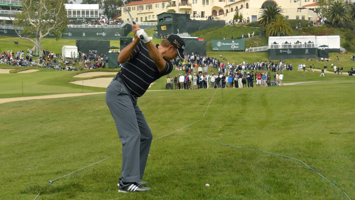 Retief Goosen makes his approach shot on the ninth hole during the third round of the Northern Trust Open at Riviera Country Club on Saturday.