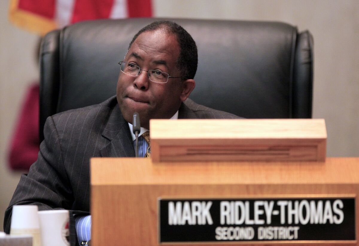FILE - In this Jun 1, 2010, file photo, Los Angeles County Supervisor Mark Ridley-Thomas casts the deciding vote for the Board of Supervisors 3-2 vote to join the city in its economic boycott of Arizona over its SB 1070 law targeting illegal immigrants in Los Angeles. Longtime politician Mark Ridley-Thomas and the former dean of the School of Social Work at USC were indicted Thursday, Oct. .14, 2021, on federal corruption charges that allege a bribery scheme in which a Ridley-Thomas relative received substantial benefits from the university in exchange for Ridley-Thomas supporting county contracts and lucrative contract amendments with the university while he served on the Los Angeles County Board of Supervisors. (AP Photo/Damian Dovarganes, File)