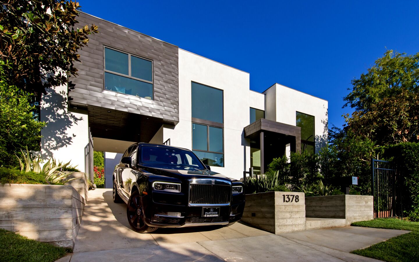 The fresh contemporary home in Hollywood Hills West is nicknamed the 'Solarium' for its voluminous step-down living room, which has a wall of steel-framed windows. Listed for $9.995 million, the multi-level house has six bedrooms and seven bathrooms in more than 6,500 square feet of space. There's also separate guest quarters. Museum-like interiors feature gallery walls and high ceilings ideal for showcasing artwork. The chef's kitchen is equipped with an island and French doors that open to the backyard. (Marc Angeles / Unlimited Style Real Estate Photography)