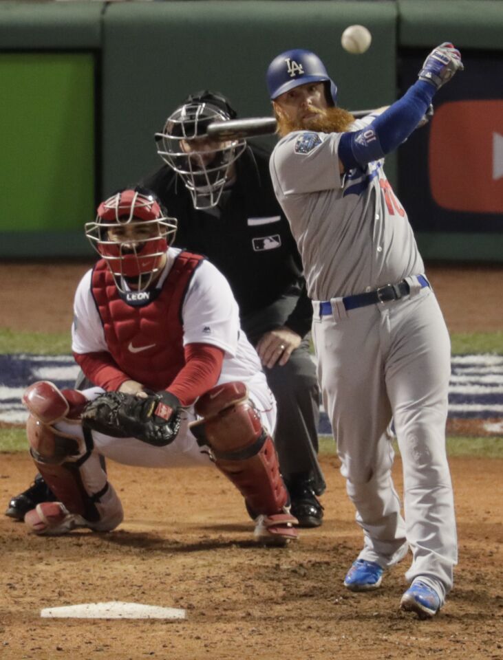 Justin Turner slashes a single in game one of the 2018 Word Series at Fenway Park.