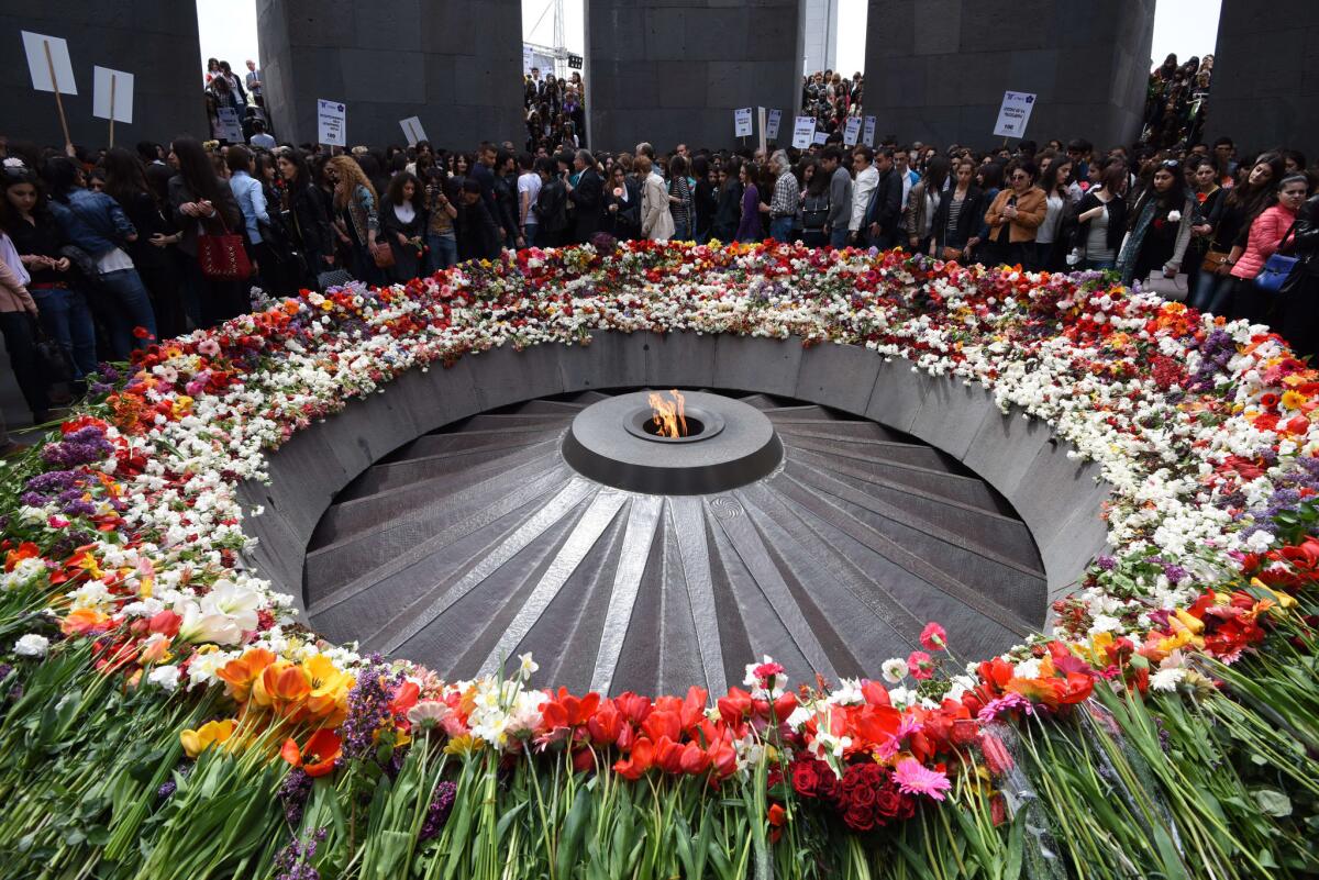People lay flowers at the Tsitsernakaberd Armenian Genocide Memorial in Yerevan, Armenia, on Tuesday.