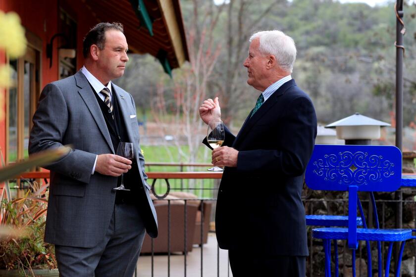 In this March 23, 2012, photo, Reverge Anselmo, owner of Anselmo Vineyards near Shingletown, Calif., talks with friend and U.S. Retired Marine Corps Col. Tim Geraghty. They met with reporters before a fundraiser featuring conservative columnist Ann Coulter. (AP Photo/The Record Searchlight, Greg Barnette)