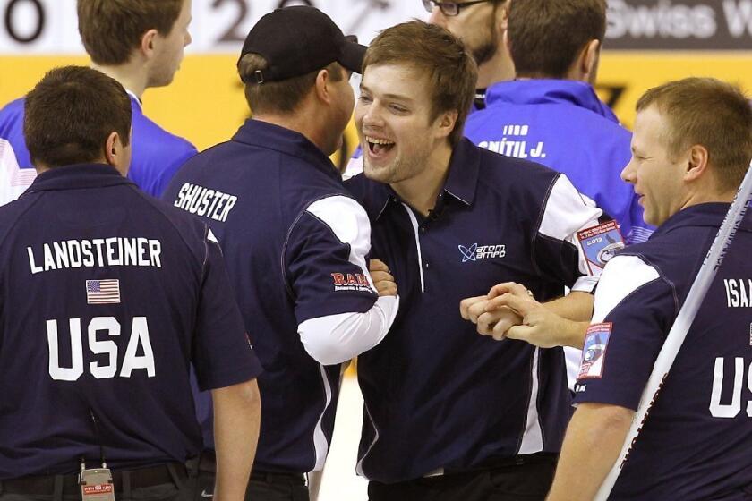 U.S. curling team members celebrate after a victory Sunday in Germany that will qualify them for the 2014 Olympics. From left are John Landsteiner, John Shuster, Jared Zezel and Jeff Isaacson.