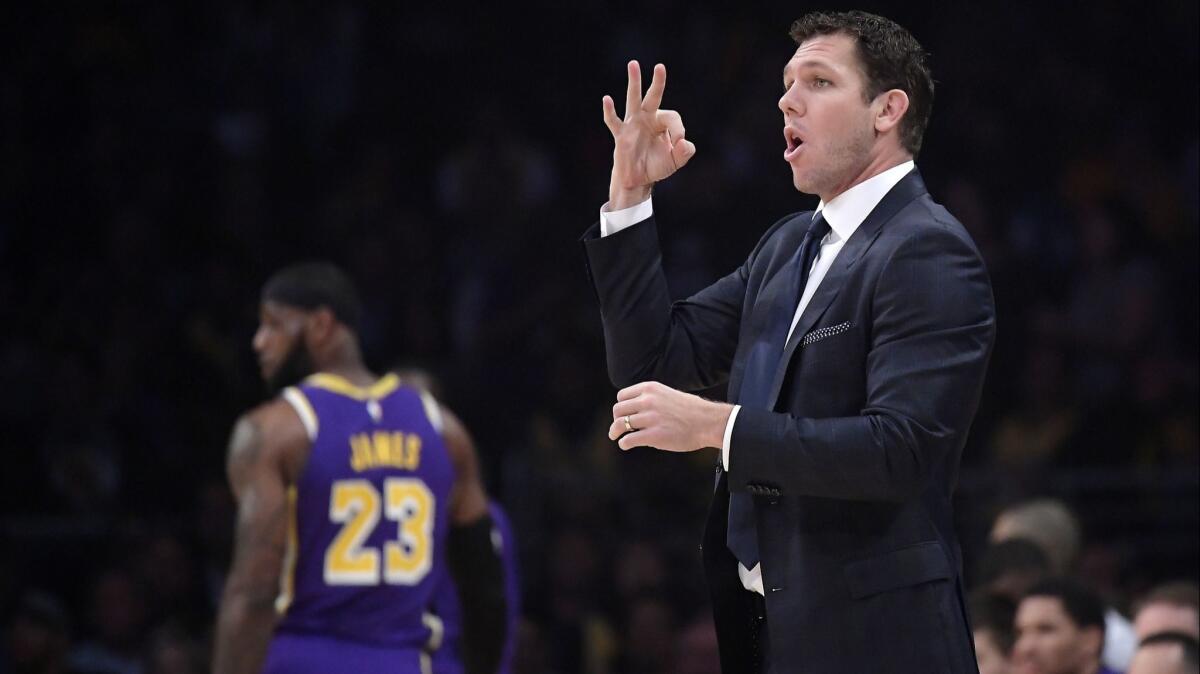 Lakers coach Luke Walton gestures as forward LeBron James stands in the background during a game against Minnesota on Nov. 7 at Staples Center.