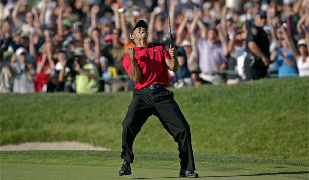 Tiger Woods celebrates on the 18th green after sinking a putt for a birdie to force a playoff with Rocco Mediate during the final round of the U.S. Open at San Diego-owned Torrey Pines in 2008.