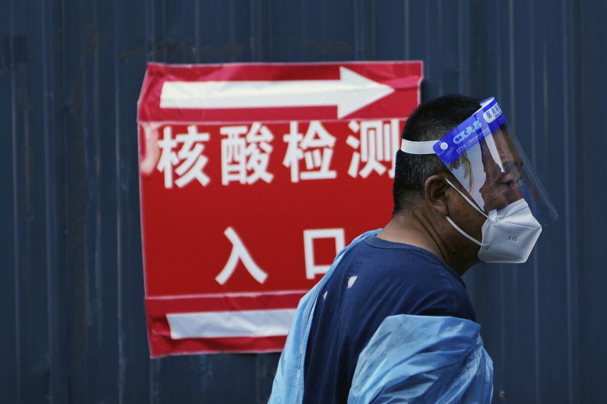 Volunteer in protective gear at a coronavirus testing site in Beijing