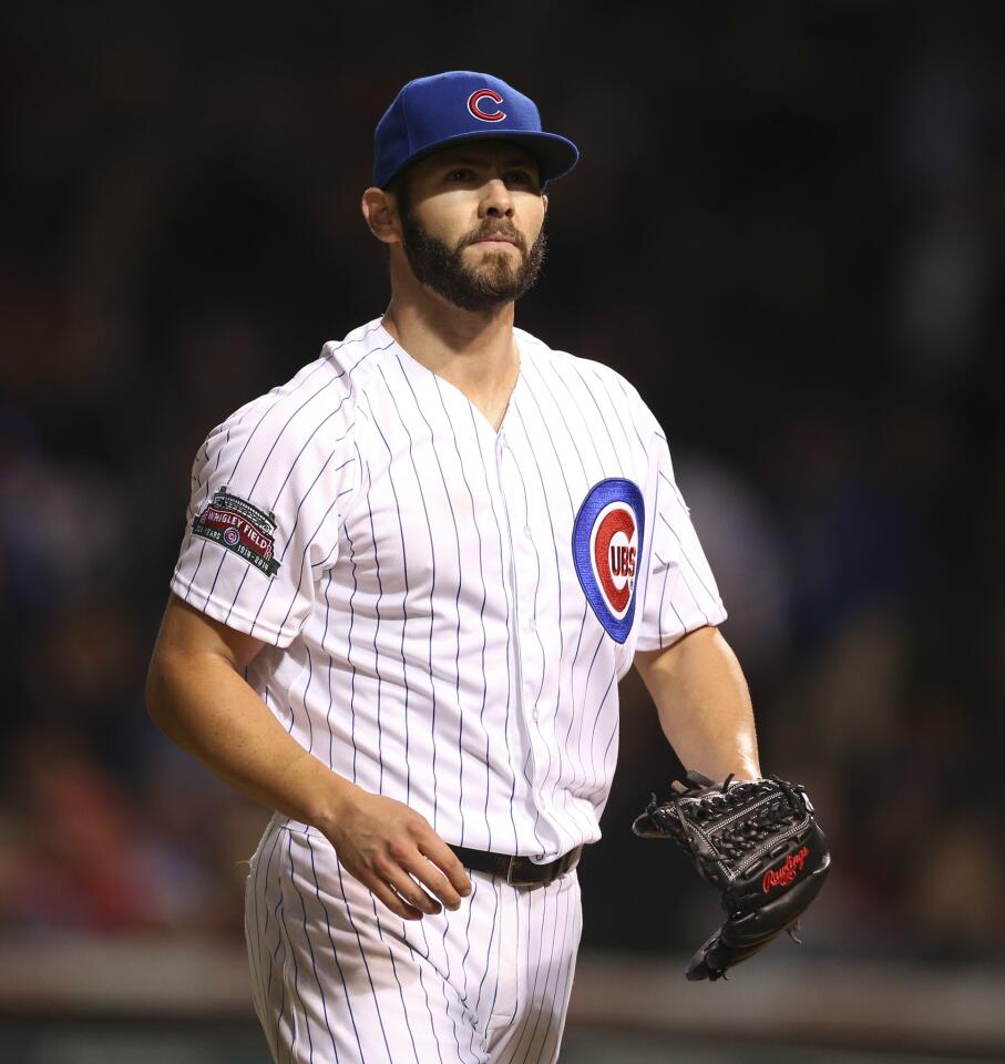 Cubs starting pitcher Jake Arrieta walks off the mound, after he struck out the Reds' Todd Frazier during the seventh inning.