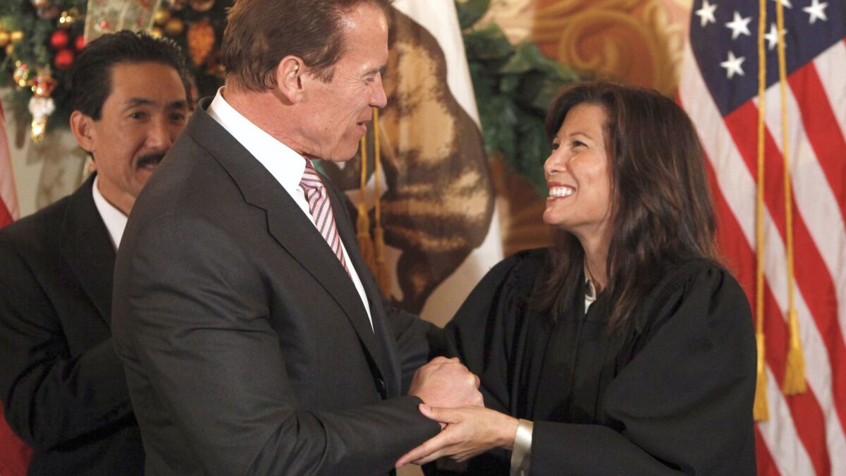 Gov. Arnold Schwarzengger congratulates Tani Cantil-Sakauye after he swore her in as California Supreme Court chief justice at the Capitol in Sacramento in 2010.