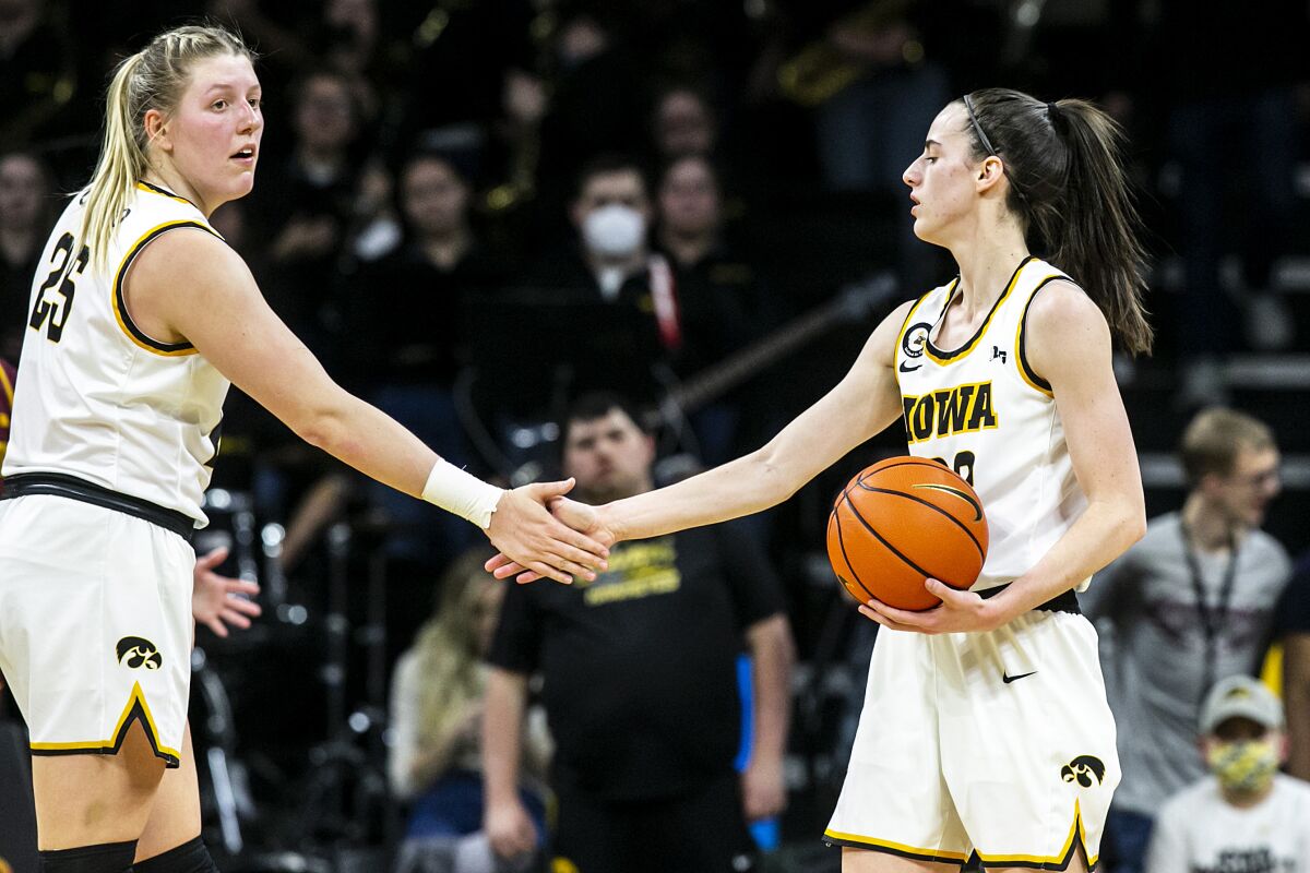 Iowa guard Caitlin Clark, right, gets a high-five from center Monika Czinano during the team's NCAA college basketball game against Iowa on Wednesday, Feb. 9, 2022, in Iowa City, Iowa. (Joesph Cress/Iowa City Press-Citizen via AP)