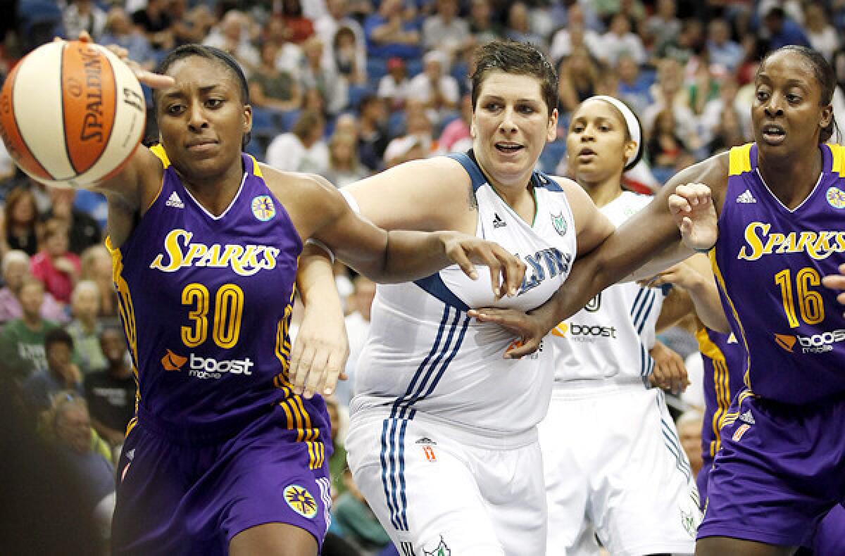 Sparks forward Nneka Ogwumike (30) tries to grab a loose ball in front of Lynx forward Janel McCarville during the second half of their game Wednesday night in Minneapolis.