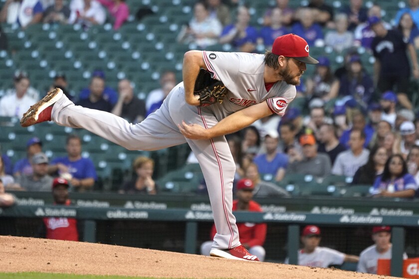 Cincinnati Reds starting pitcher Wade Miley watches a throw during the first inning of the team's baseball game against the Chicago Cubs on Tuesday, Sept. 7, 2021, in Chicago. (AP Photo/Charles Rex Arbogast)