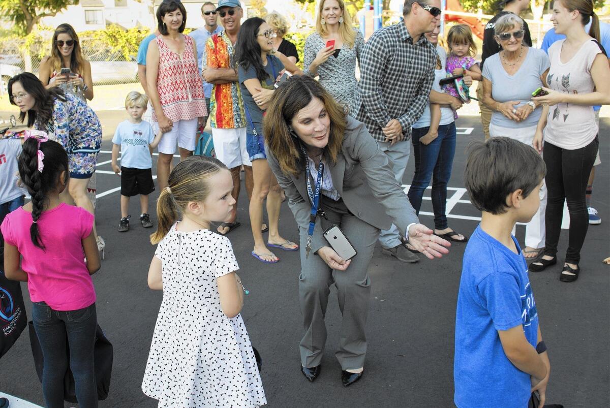 Principal Laura Sacks helps line up children for Shari Gaeta's transitional kindergarten class during the first day back to school at Mariners Elementary School in Newport Beach on Tuesday.