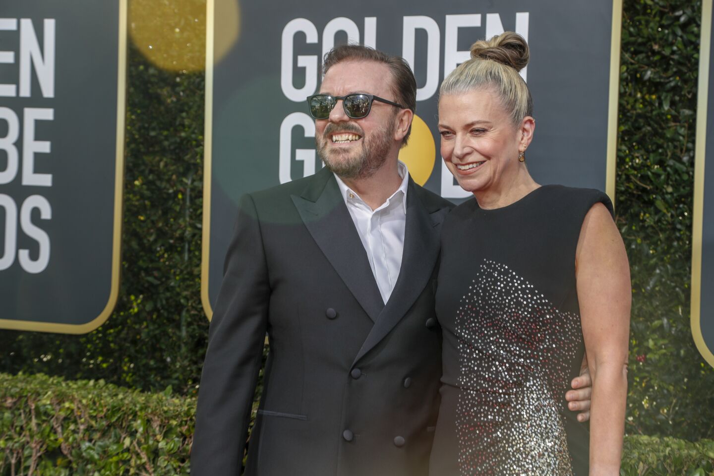 Host Ricky Gervais and Jane Fallon arrive at the 77th Golden Globe Awards