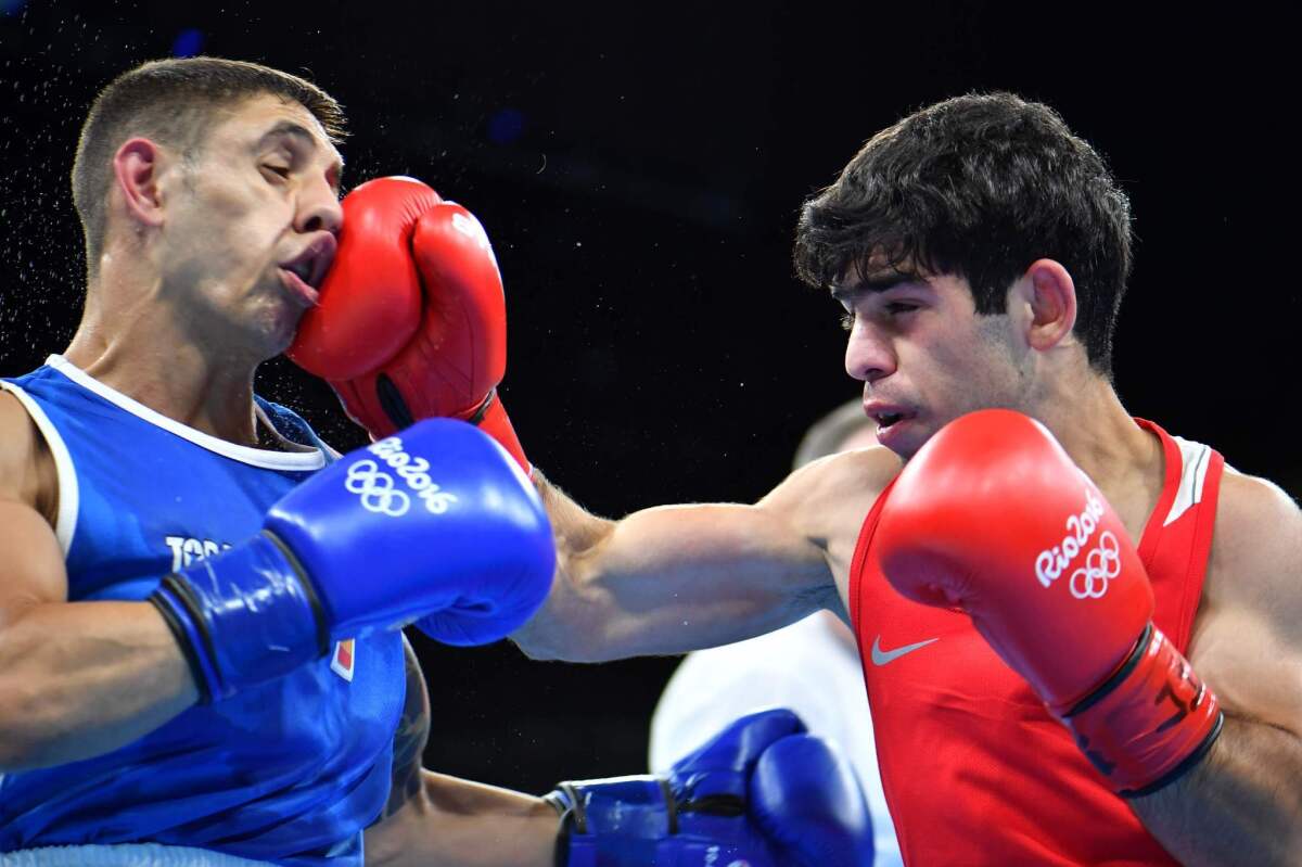 Armenia's Artur Hovhannisyan, right, lands a punch on Spain's Samuel Carmona Heredia during a men's light flyweight match on Aug. 6 at the Olympic Games in Rio de Janeiro.