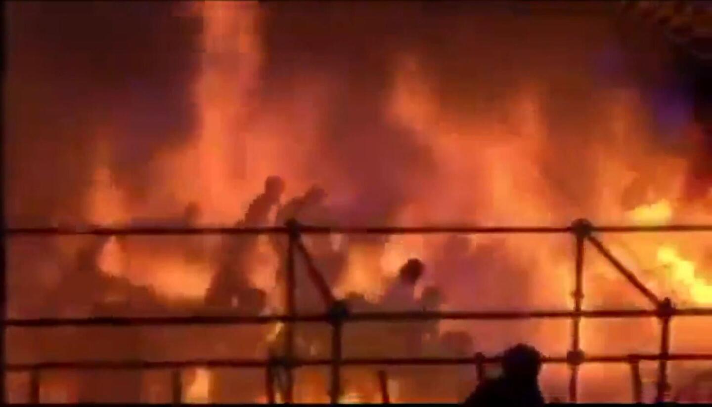 This frame grab from video footage provided by Apple Daily on June 28, 2015 shows revelers being engulfed by flames at the Formosa Fun Coast water park in Pali district, in New Taipei City, on June 27, 2015. (Graphic content)