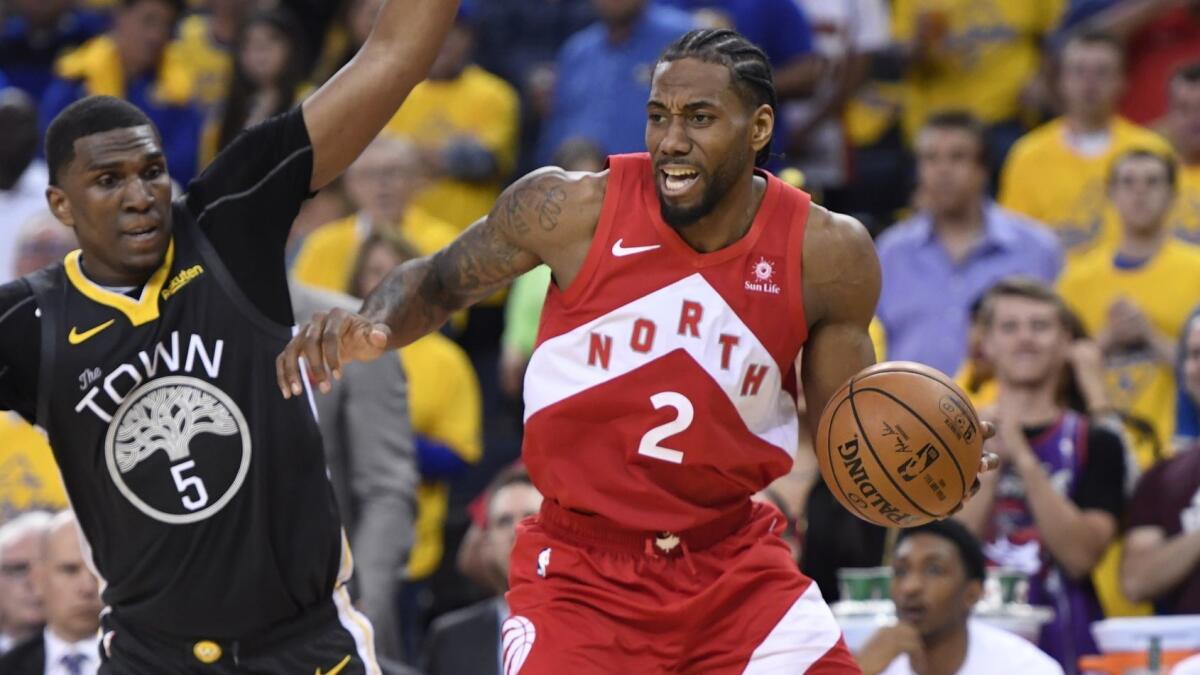 Toronto Raptors forward Kawhi Leonard drives past Golden State Warriors center Kevon Looney during Game 6 of the NBA Finals on June 13.
