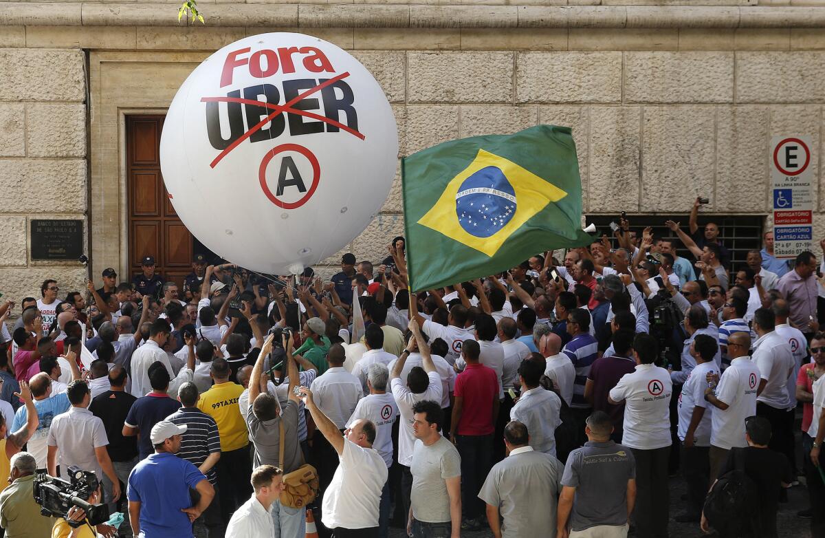 Taxi drivers protest against the ride-booking app company Uber outside City Hall in Sao Paulo, Brazil this month.