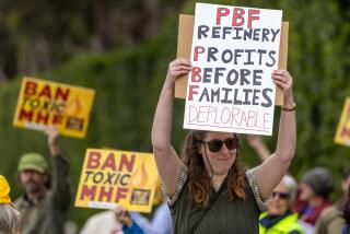 TORRANCE, CA - FEBRUARY 17: Isabel (Douvan) Schwartz and others on the 9th. anniversary of the blast and to protest inaction by the industry and regulators, the at Torrance Refinery Action Alliance holds a protest Park Torrance, CA. (Irfan Khan / Los Angeles Times)