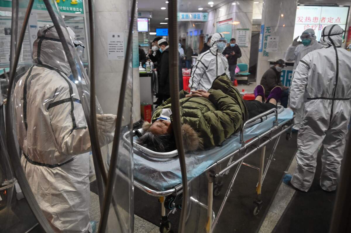 Medical staff  arrive with a patient at the Wuhan Red Cross Hospital in Wuhan. The Chinese army deployed medical specialists to the epicenter of the coronavirus viral outbreak.
