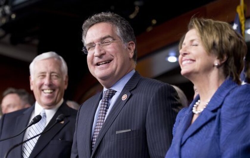 Rep. Joe Garcia, D-Fla., center, House Minority Whip Steny Hoyer, D-Md., left, and House Minority Leader Nancy Pelosi of Calif., laugh in reaction to Garcia's statement that he corrected during a news conference on immigration reform, Wednesday, Oct. 2, 2013, on Capitol Hill in Washington. House Democrats have unveiled an immigration bill that includes a path to citizenship for the 11 million immigrants living here illegally and tightens border security. (AP Photo/Manuel Balce Ceneta)