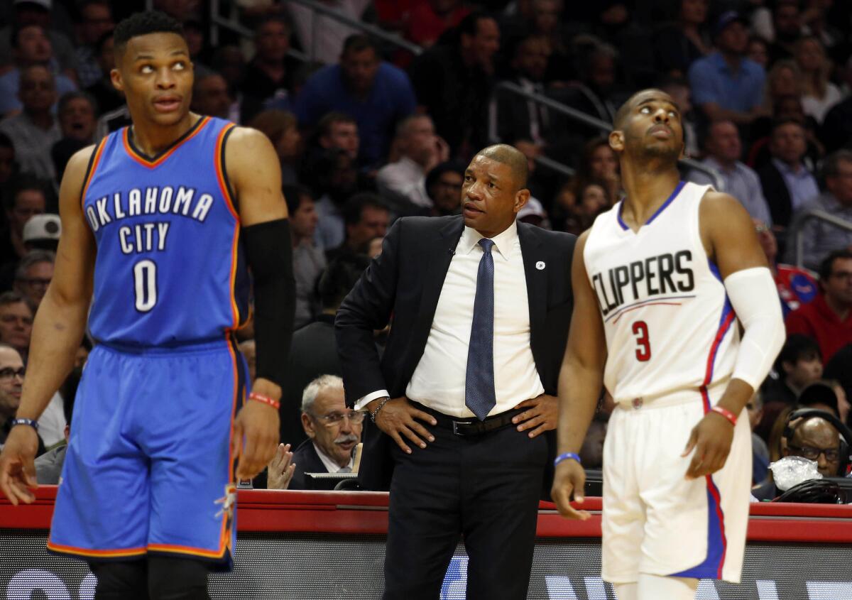 Thunder guard Russell Westbrook and Clippers guard Chris Paul both look up at the scoreboard during a game on March 2.