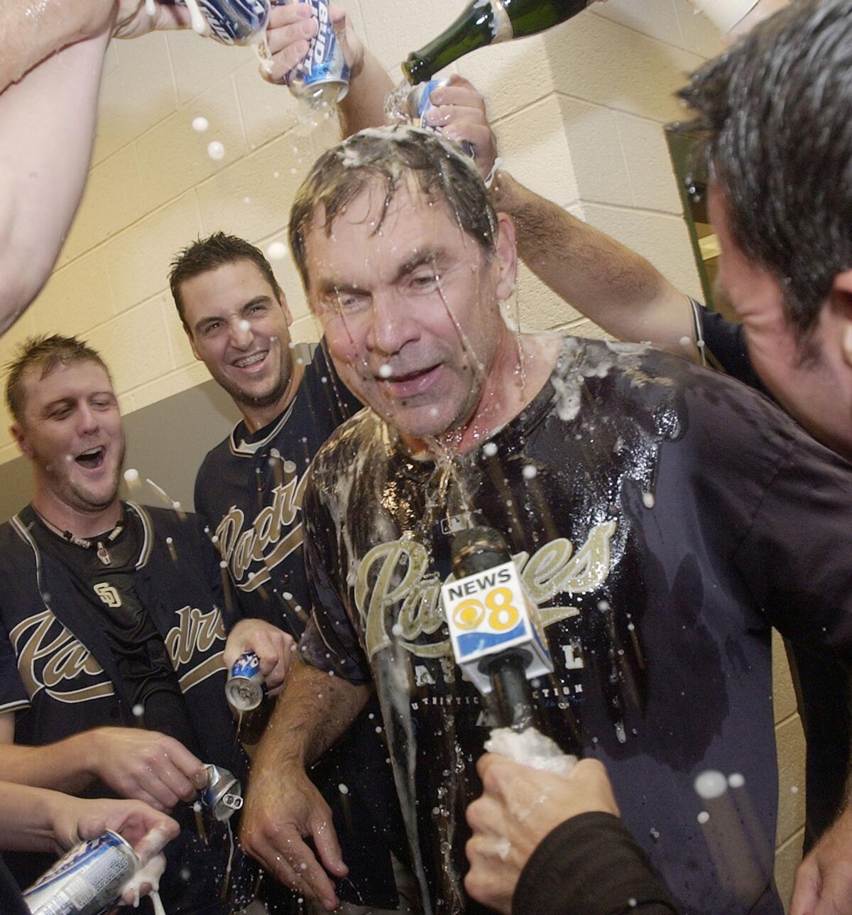 Manager Bruce Bochy gets drenched with beer and champagne after Padres clinched playoff spot Sept. 30, 2006, in Phoenix.