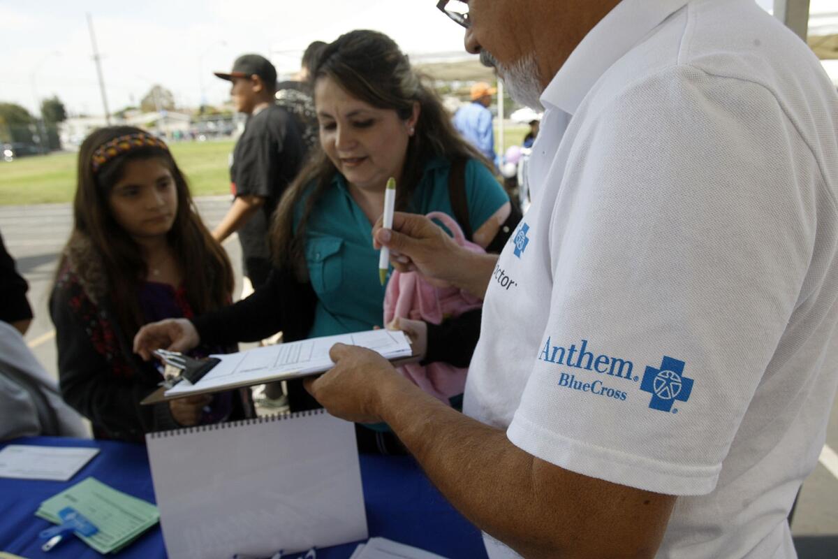 An Anthem Blue Cross representative works in a booth at the East Los Angeles Health Fair held at David Wark Griffith Middle School last September.