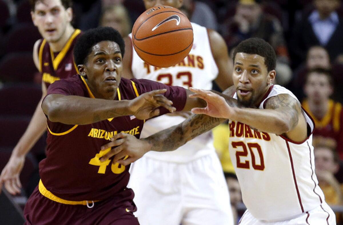 Arizona State forward Shaquielle McKissic and USC guard J.T. Terrell chase after a loose ball in the first half of their Pac-12 Conference game on Thursday night at the Galen Center.