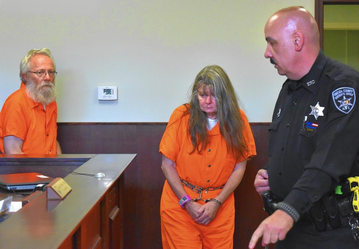 Bruce and Deborah Leonard enter court for their arraignment in New Hartford, N.Y. They are charged with manslaughter in the beating death of their 19-year-old son. Four others linked to their church also face charges.
