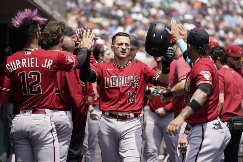 Arizona Diamondbacks' Nick Ahmed is greeted in the dugout after his two-run home run during the second inning of a baseball game against the Detroit Tigers, Saturday, June 10, 2023, in Detroit. (AP Photo/Carlos Osorio)