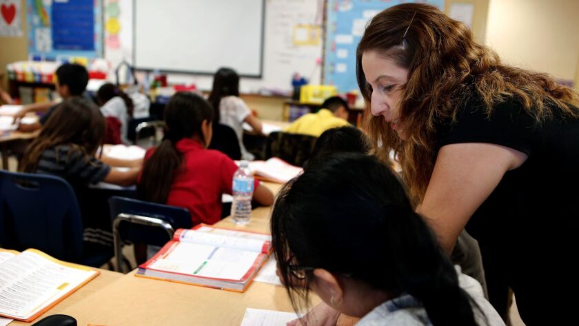 A teacher works with her fifth-grade students in South Los Angeles on November 17, 2016.
