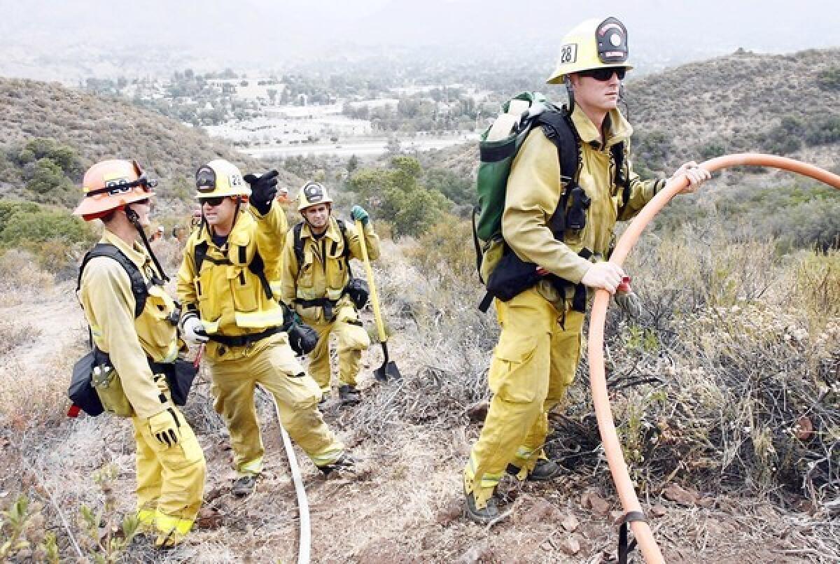 FILE PHOTO: Glendale firefighters participate in a brush fire drill alongside L.A. City Fire Dept., L.A. County Fire Dept., and the USDA Forest Service on a hillside above Sunland Blvd. in Sunland on Thursday, July 12, 2012. Glendale Fire Department is looking to hire 15 new firefighters in August 2013.