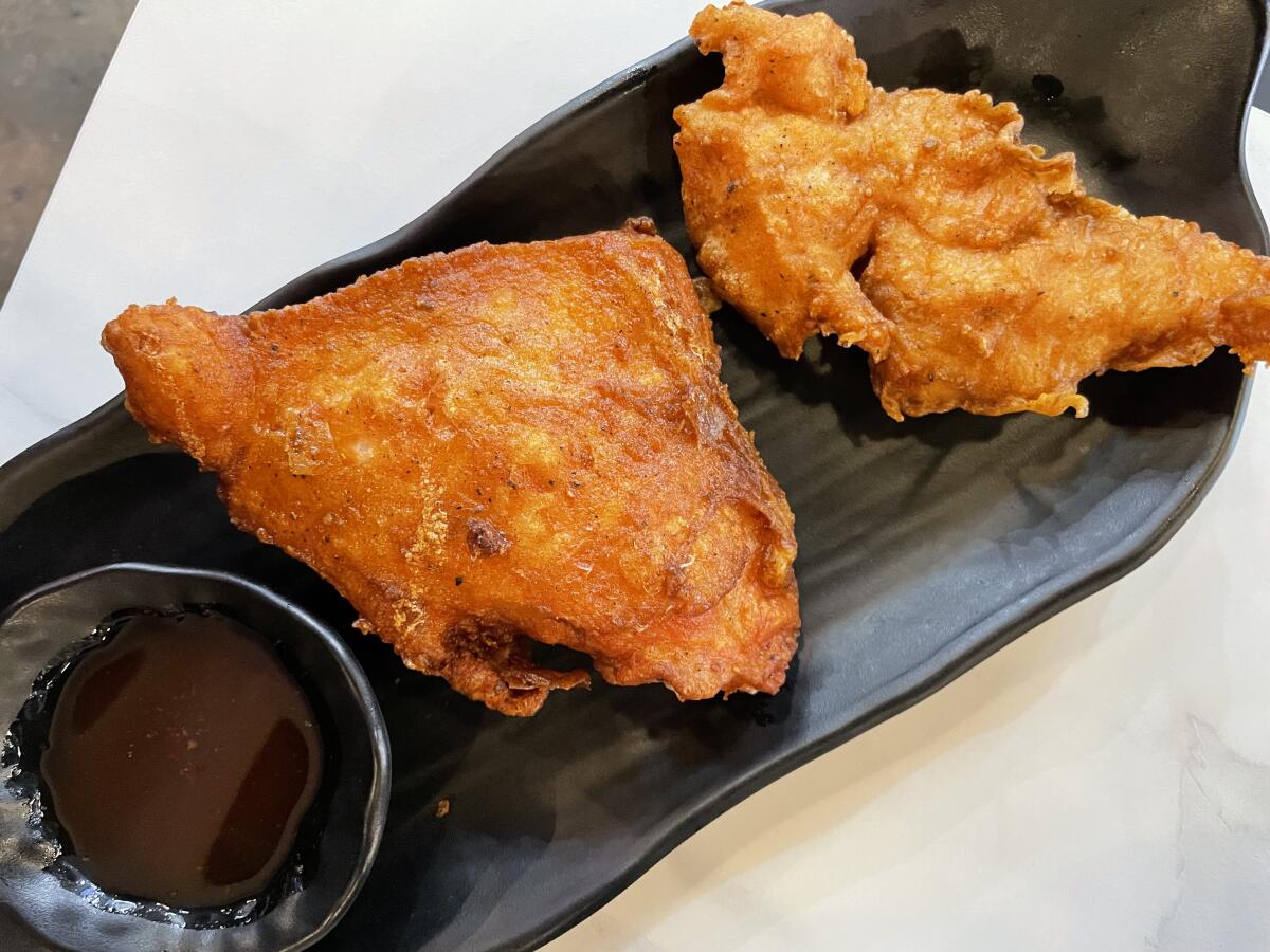 Two pieces of fried chicken.